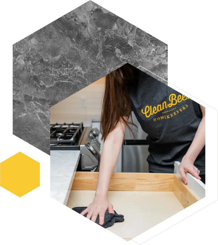 A professional cleaner from Clean Bees Homekeepers wiping the inside of a kitchen drawer as part of a thorough move-out cleaning checklist in Fort Collins.