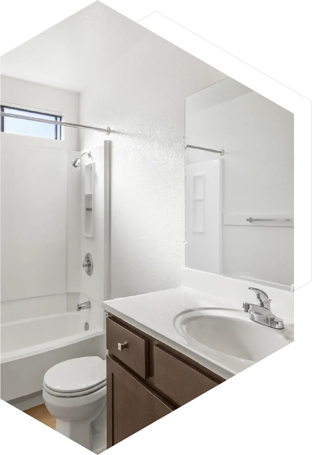 A sparkling clean bathroom with a white tub and toilet, professionally cleaned by Clean Bees Homekeepers in Fort Collins.